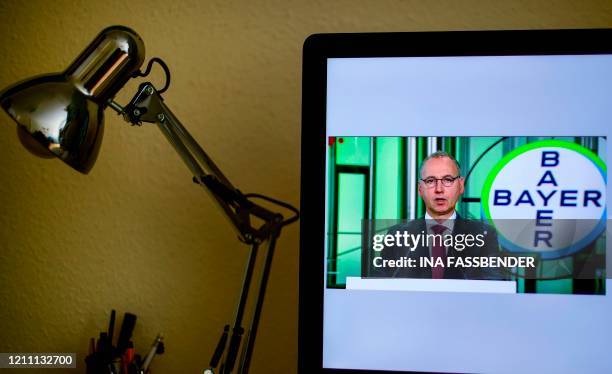 The CEO of German chemicals giant Bayer, Werner Baumann, is displayed on a computer screen during his speech of the group's online annual general...