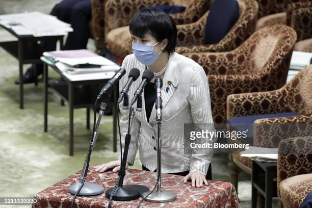 Sanae Takaichi, Japan's internal affairs minister, wears a protective mask as she speaks during a budget committee session at the lower house of...