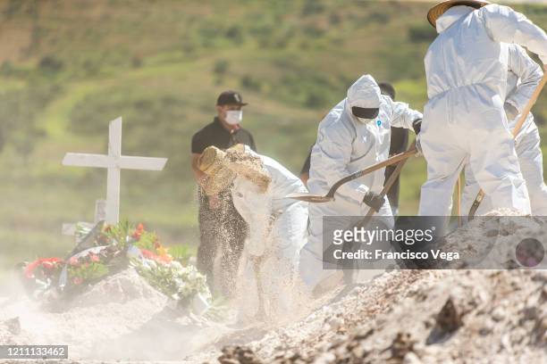 Cemetery workers dig a grave at Municipal cemetery Panteón número 13 on April 27, 2020 in Tijuana, Mexico. Baja California state remains as one of...