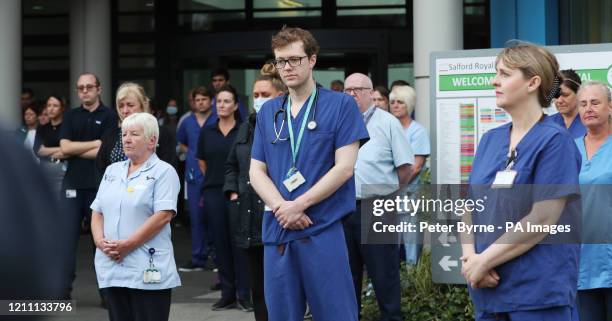 Staff stand outside Salford Royal Hospital in Manchester during a minute's silence to pay tribute to the NHS staff and key workers who have died...