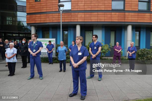 Staff stand outside Salford Royal Hospital in Manchester during a minute's silence to pay tribute to the NHS staff and key workers who have died...