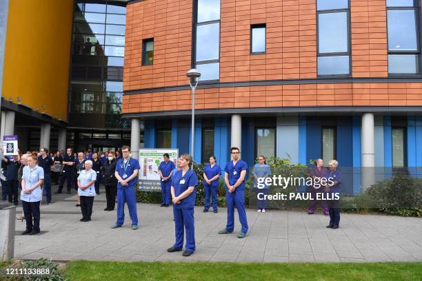 Staff pause for a minute's silence to honour UK key workers, including NHS staff, health and social care workers, who have died during the...