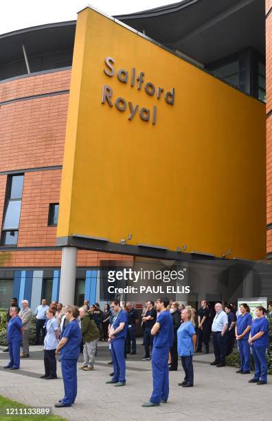 Staff pause for a minute's silence to honour UK key workers, including NHS staff, health and social care workers, who have died during the...