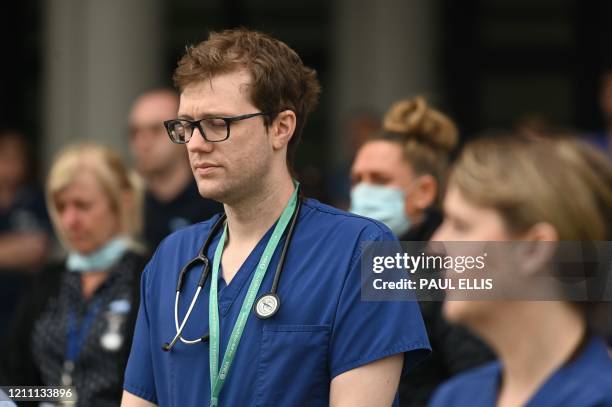 Staff pause for a minute's silence to honour UK key workers, including NHS staff, health and social care workers, who have died during the...