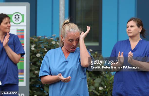 Staff react outside Salford Royal Hospital in Manchester during a minute's silence to pay tribute to the NHS staff and key workers who have died...