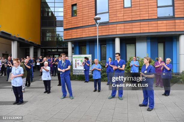 Staff applaud after pausing for a minute's silence to honour UK key workers, including NHS staff, health and social care workers, who have died...