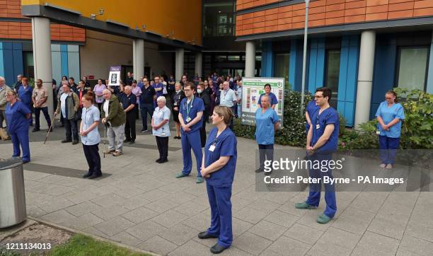 Staff stand outside Salford Royal Hospital in Manchester during a minute's silence to pay tribute to the NHS staff and key workers who have died...