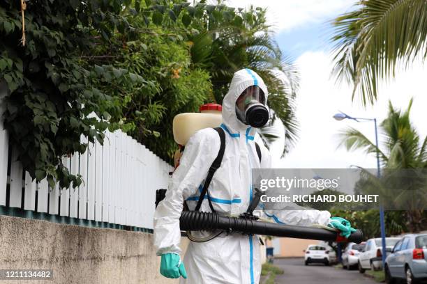 Worker of the vector control team of the French Indian Ocean island of La Reunion departmental fire service and regional public health authorities...