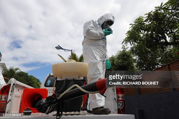 Worker of the vector control team of the French Indian Ocean island of La Reunion departmental fire service and regional public health authorities...