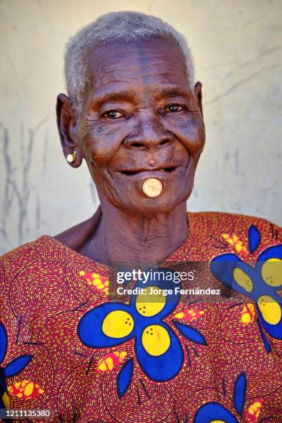 Portrait of an old Zulawa woman with lip piercing and faded traditional tattoos.