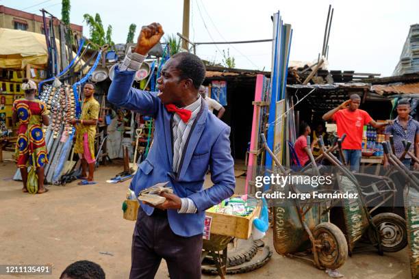 Evangelist preacher screaming in the streets of Abakaliki with a bible in hand.