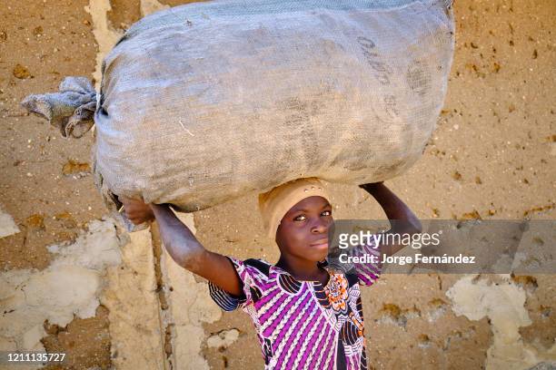 Zulawa girl carrying a large sack over her head.