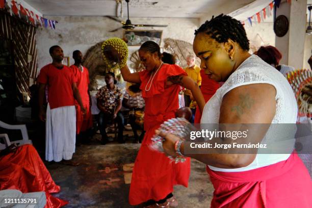 Women dancing during a ceremony in a temple dedicated to the Orisha deity called Olokun. Olokun is an orisha spirit in the Yoruba religion which is...