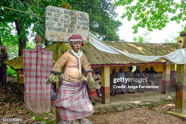 Council of elders gathered at the Edda court of law, protected by ritual statues.