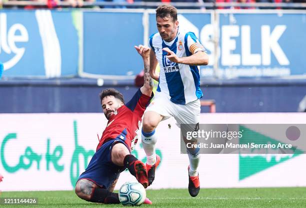 Victor Sanchez of RCD Espanyol duels for the ball with Ruben Garcia of CA Osasuna during the Liga match between CA Osasuna and RCD Espanyol at El...