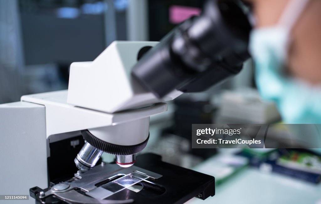 Scientist Researcher Using Microscope In Laboratory Medical Healthcare ...