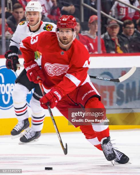 Darren Helm of the Detroit Red Wings skates up ice with the puck against the Chicago Blackhawks during an NHL game at Little Caesars Arena on March...