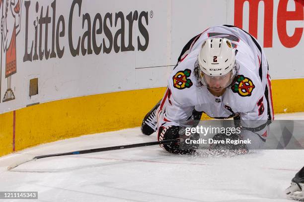 Duncan Keith of the Chicago Blackhawks looks for the puck on his knees against the Detroit Red Wings during an NHL game at Little Caesars Arena on...