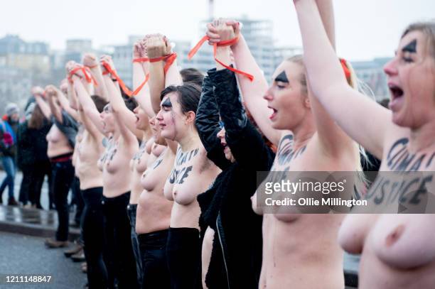 Female members of the Extinction Rebellion Climate Crisis activist group protest topless while blocking all traffic from using Waterloo Bridge during...