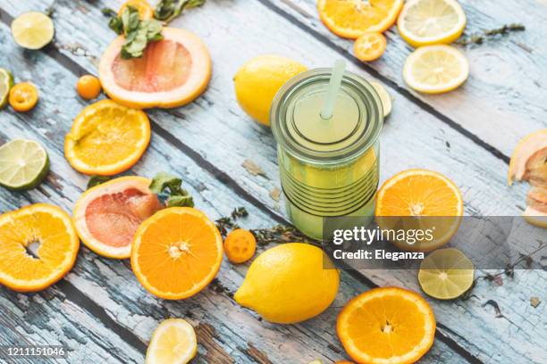 lemonade and slices of citrus fruit - lemon juice stock pictures, royalty-free photos & images