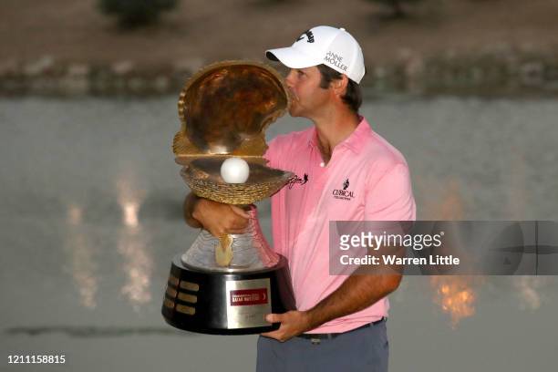 Jorge Campillo of Spain poses for a photograph with the trophy following victory during Day 4 of the Commercial Bank Qatar Masters at Education City...