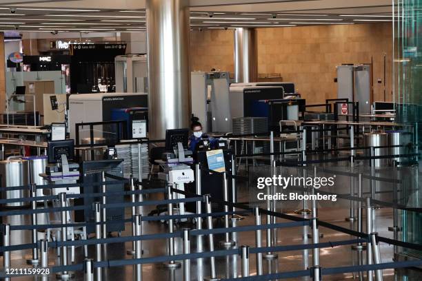 Transportation Security Administration agent wears a protective mask at San Diego International Airport in San Diego, California, U.S., on Monday,...