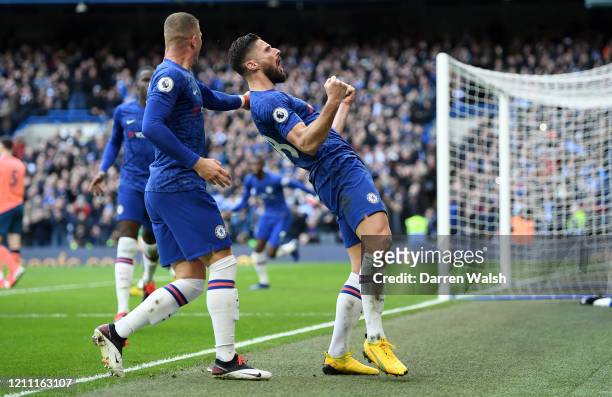 Olivier Giroud of Chelsea celebrates with teammate Ross Barkley after scoring his team's fourth goal during the Premier League match between Chelsea...
