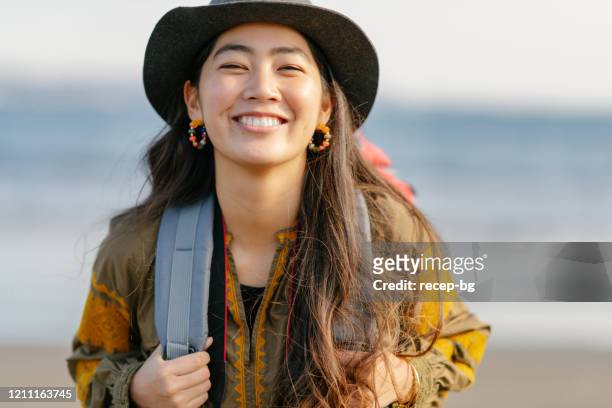 close-up portait of happy female solo traveller - japanese woman stock pictures, royalty-free photos & images