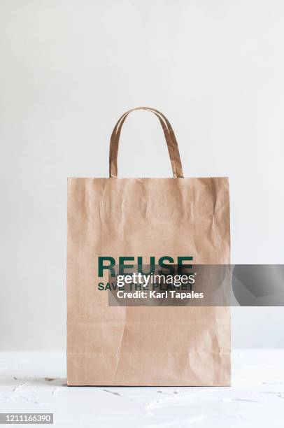 a still life of paper bag on a white background - human role fotografías e imágenes de stock