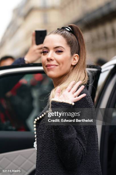 Ashley Benson wears a pearl trimmed black tweed coat, outside Giambattista Valli, during Paris Fashion Week - Womenswear Fall/Winter 2020/2021, on...