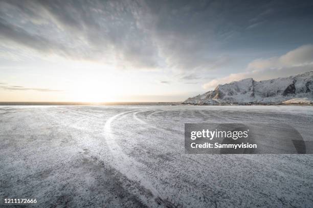 road against snowcapped mountain - snow road stock-fotos und bilder