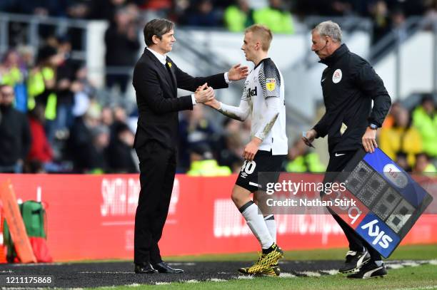 Manager of Derby County, Phillip Cocu shakes hands with Louie Sibley of Derby County as he is substituted during the Sky Bet Championship match...