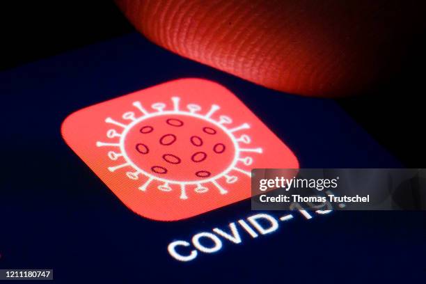 The logo of tracking app COVID-19! is shown on the display of a smartphone on April 22, 2020 in Berlin, Germany.