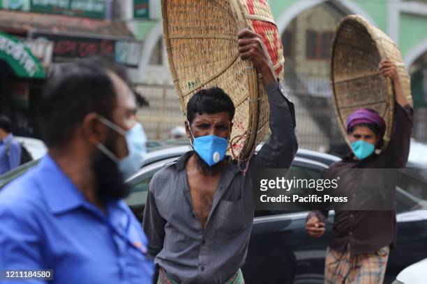 Daily labourers are wearing face-masks as a precautionary act to be safe from being infected by CoVid-19. Daily labors won't be able to feed...
