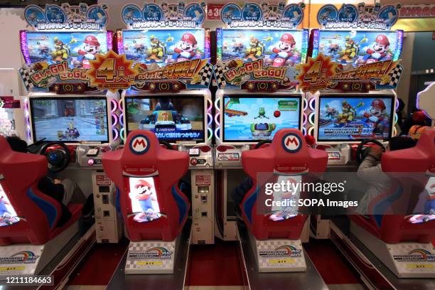 Children playing Mario Kart Arcade GP DX game at Tatio Game Center in Tokyo. Three years ago, the eighth major installment in the Mario Kart series...