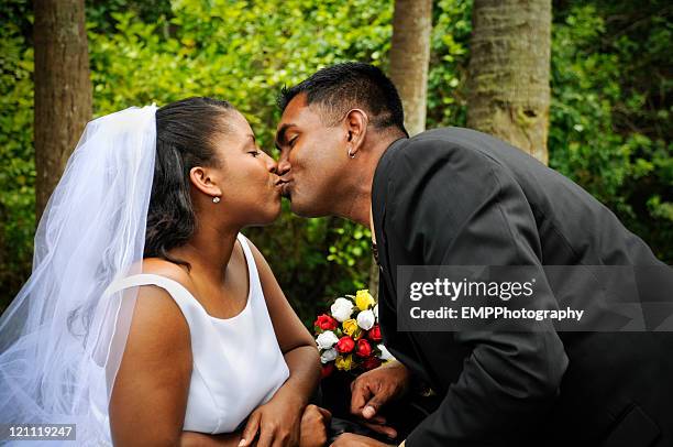 diverse couple sharing a wedding kiss - african americans getting married stock pictures, royalty-free photos & images