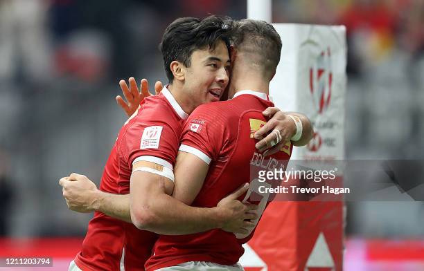 Nathan Hirayama and Justin Douglas of Canada celebrate after Douglas scored a try against Spain during their rugby sevens match at BC Place on March...