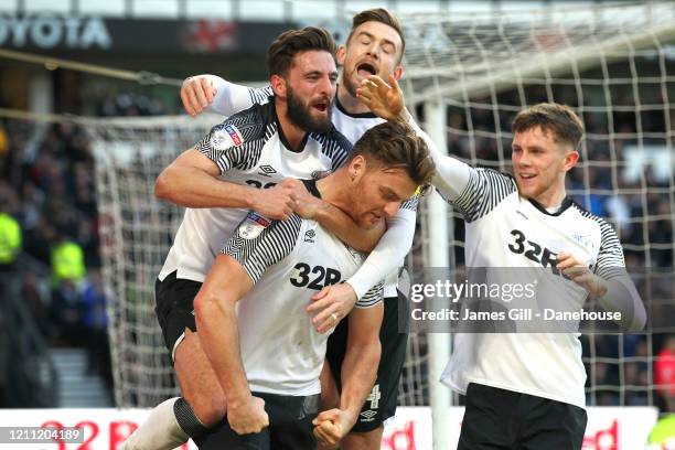 Chris Martin of Derby County is mobbed by team mates after scoring their third goal from the penalty spot during the Sky Bet Championship match...