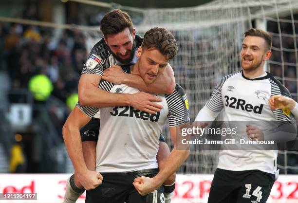 Chris Martin of Derby County is mobbed by team mates after scoring their third goal from the penalty spot during the Sky Bet Championship match...