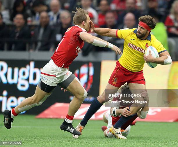 Harry Jones and Lucas Hammond of Canada work to bring down Manuel Sainz-Trapaga of Spain during their rugby sevens match at BC Place on March 08,...