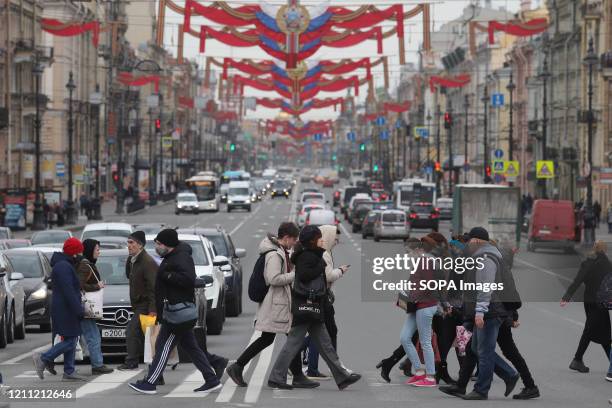 People cross Nevsky Prospect during the covid 19 pandemic. Russian President, Vladimir Putin extends off-work days till 11 May as at least 93 558...