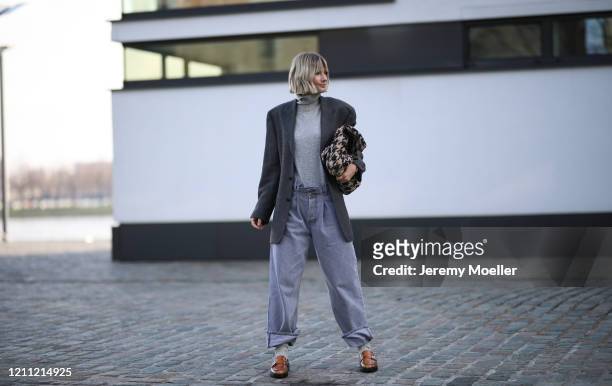 Kathrin Bommann wearing vintage ysl blazer, Raey pants, Uniqlo turtleneck, Chanel bag and Ganni loafer on March 07, 2020 in Cologne, Germany.