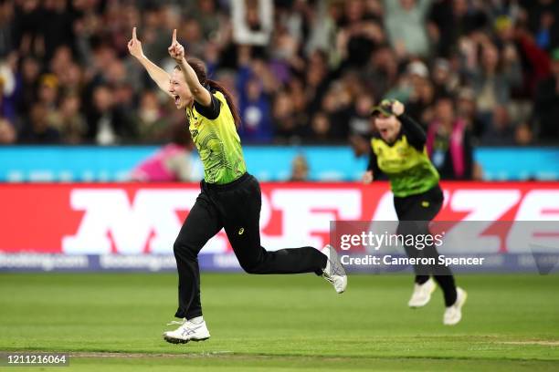 Megan Schutt of Australia celebrates taking the final wicket dismissing Poonam Yadav of India during the ICC Women's T20 Cricket World Cup Final...