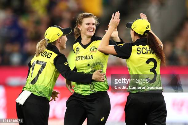Jess Jonassen of Australia celebrates dismissing Radha Yadav of India with Meg Lanning of Australia and Megan Schutt of Australia during the ICC...