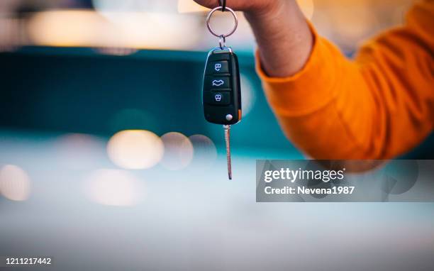 man holding a car key - orange car stock pictures, royalty-free photos & images