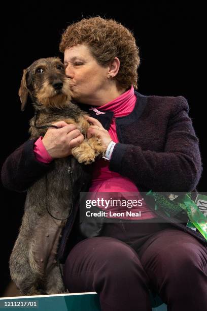 Maisie the Wire Haired Dachshund is kissed by owner Kim McCalmont from Gloucestershire after winning Best in Show on the last day of Crufts Dog Show...