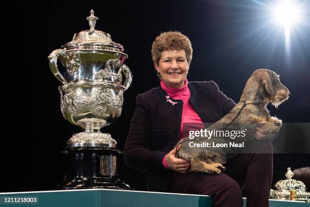 Maisie the Wire Haired Dachshund and owner Kim McCalmont from Gloucestershire pose after winning Best in Show on the last day of Crufts Dog Show at...