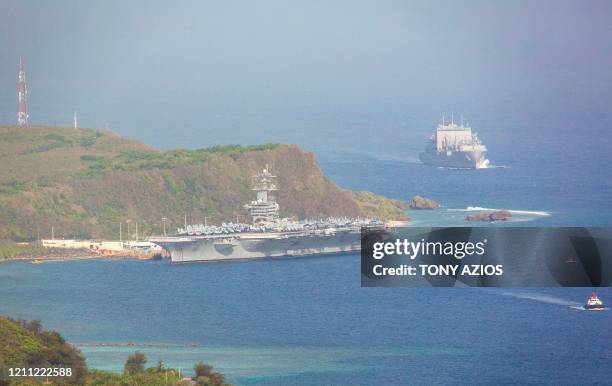 The aircraft carrier USS Theodore Roosevelt, is docked at Naval Base Guam in Apra Harbor amid the coronavirus pandemic on Monday, April 27, 2020. -...