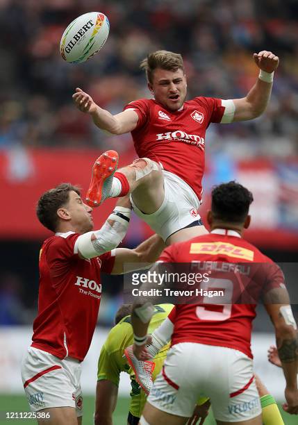 Lucas Hammond, Theo Sauder and Mike Fuailefau of Canada can't come up with the ball as Nick Malouf of Australia breaks up the play during their rugby...