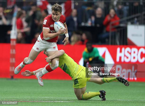 Henry Hutchison of Australia tackles Theo Sauder of Canada during their rugby sevens semi final at BC Place on March 08, 2020 in Vancouver, Canada.